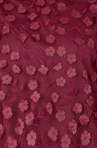 Close-up of Yumi Burgundy Sheer Sleeve flower applique top with floral embroidery on sheer fabric