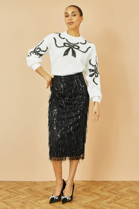 Yumi black hanging sequin fitted midi skirt with glittering movement and flattering silhouette.