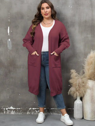 Plus size long sleeve pocketed cardigan in burgundy with open front and ribbed texture worn with casual outfit