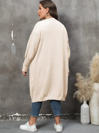 Plus size long sleeve beige cardigan with pockets and ribbed cuffs worn by woman
