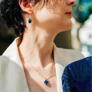 Tyche Gemstone Necklace with lapis pendant in 22k gold on recycled brass worn with matching earring
