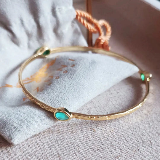 Simi Three Stone stacking bangle with Paraiba Onyx teardrop gemstones in 22kt gold plated recycled brass
