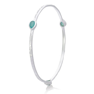 Simi Three Stone Stacking Bangle in sterling silver with three aqua Paraiba Onyx gemstones and textured design
