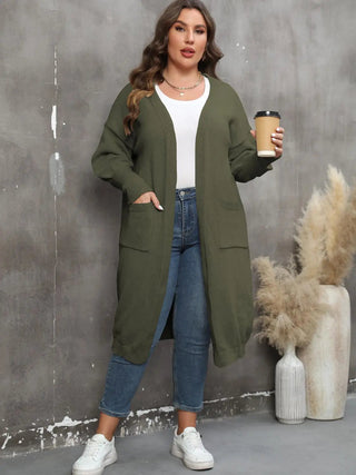 Plus size long sleeve olive green ribbed cardigan with pockets and open front, worn with jeans and white sneakers