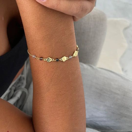 Sofia Nugget Bracelet featuring black onyx, smoky quartz, labradorite gemstones, and 22k gold beads on adjustable recycled brass chain