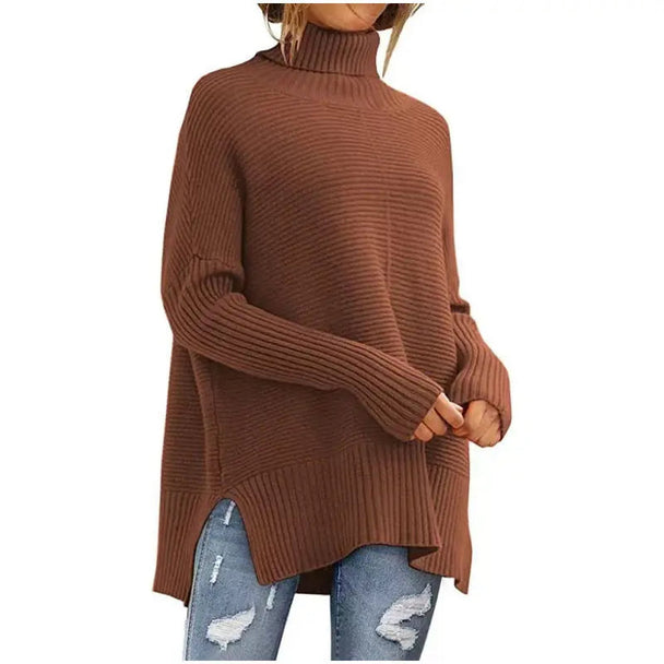 Brown oversized turtleneck batwing sleeve sweater with ribbed texture and relaxed fit worn with ripped jeans