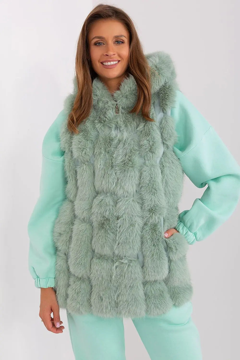 Elegant women’s hooded faux fur vest in soft green polyester with zipper and pockets for warmth and style