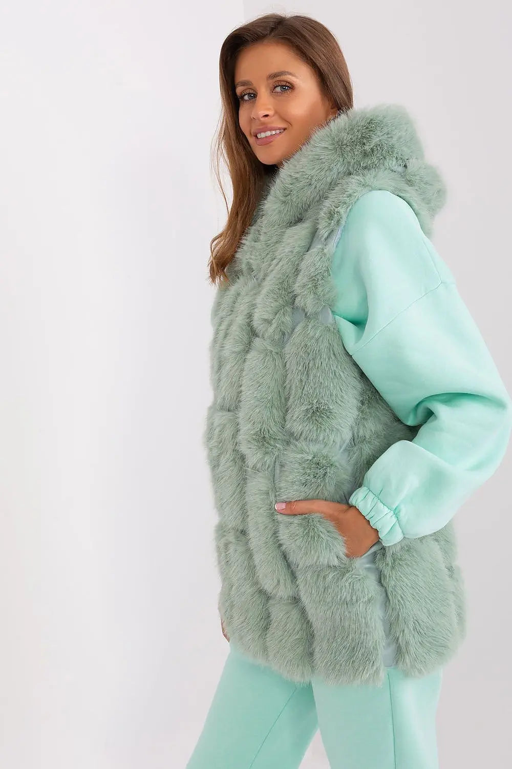 Elegant women's hooded faux fur vest in soft green polyester with zipper and pockets