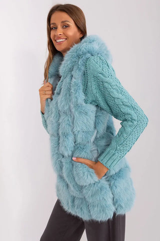 Woman wearing elegant blue hooded faux fur vest with pockets and zipper closure