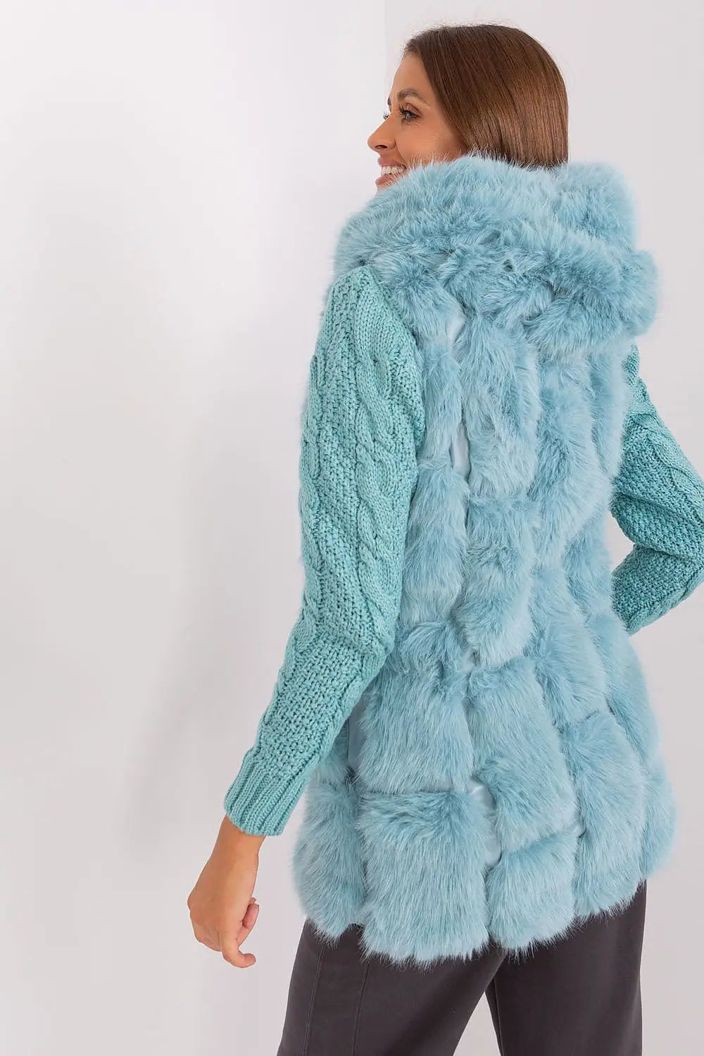 Elegant women's hooded faux fur vest in light blue, made of soft polyester with practical pockets and zipper closure