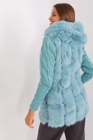Elegant women's hooded faux fur vest in light blue, made of soft polyester with practical pockets and zipper closure