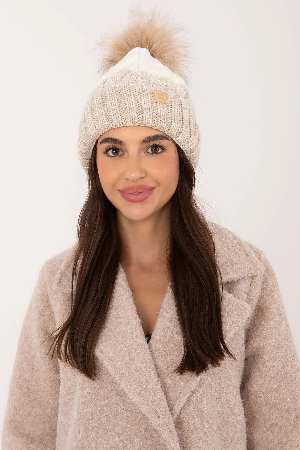 Beige two-tone winter beanie with pom-pom and fleece lining for warmth and style