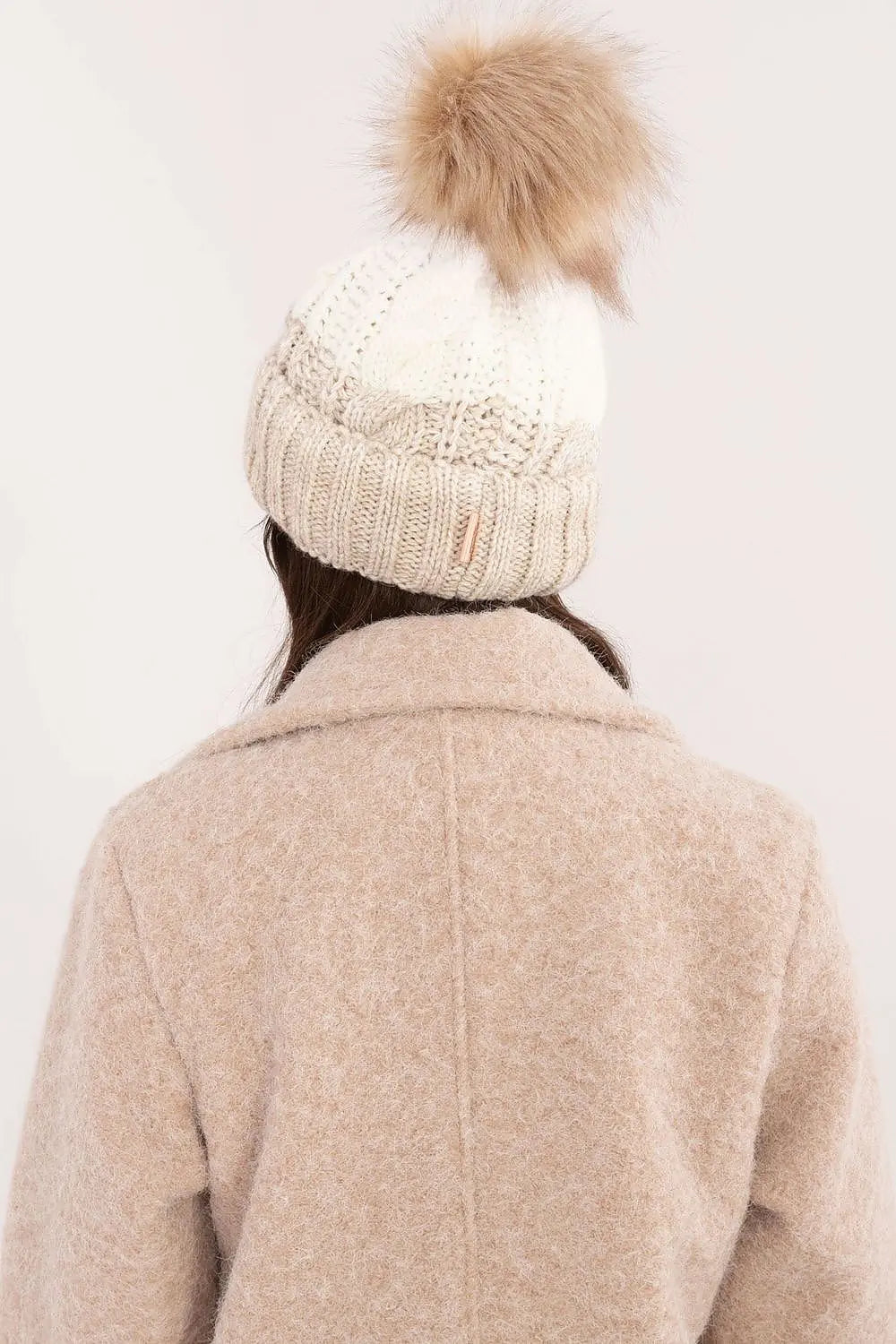 Beige two tone winter beanie with pom-pom and fleece lining for warmth and style