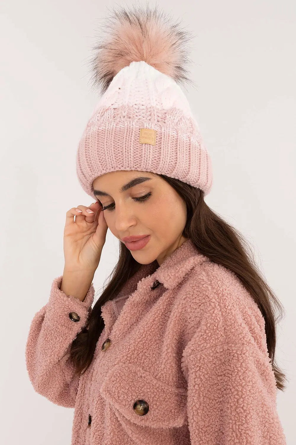 Beige two-tone winter beanie with plaid pattern, fluffy pom-pom, and fleece lining for warmth and style