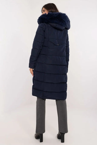 woman wearing navy long quilted down jacket with detachable fur hood standing back view
