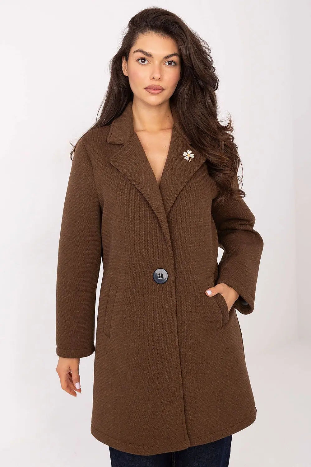 Elegant brown women’s transitional coat with lapels, button closure, slip pockets, and decorative brooch