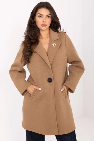 Elegant women's transitional coat in tan with lapels, button closure, slip pockets, and decorative brooch.