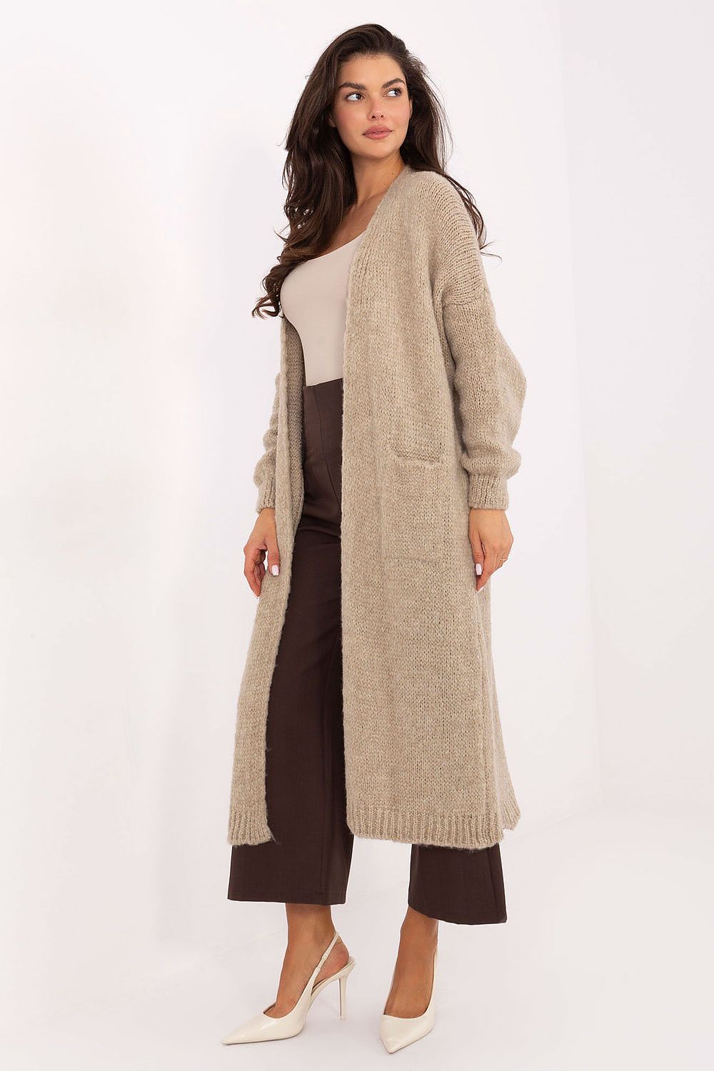 Long women's cardigan in beige with long sleeves and knee-length design, featuring slip pockets and soft textured fabric for casual and work wear