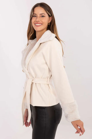 Elegant short women's coat with fur trim and belt in cream color worn by smiling model