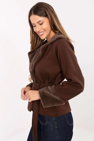 Elegant short women's coat with fur trim and waist belt in brown on model