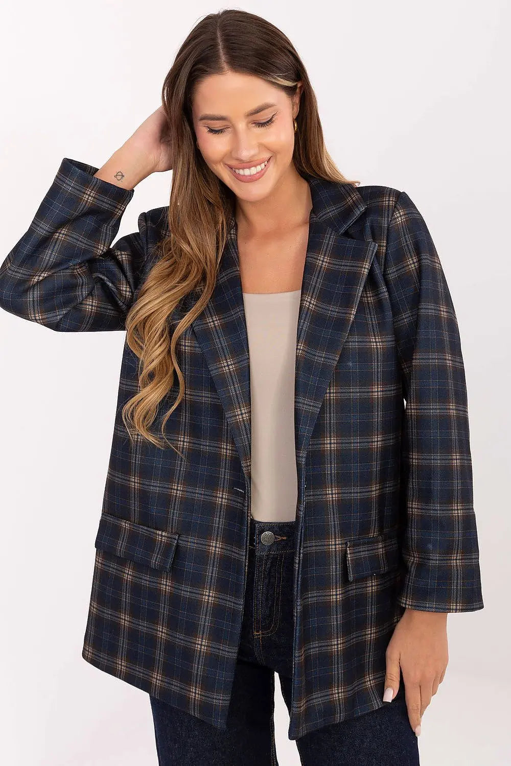 Woman wearing a stylish blue and brown checked blazer with long sleeves and shoulder pads