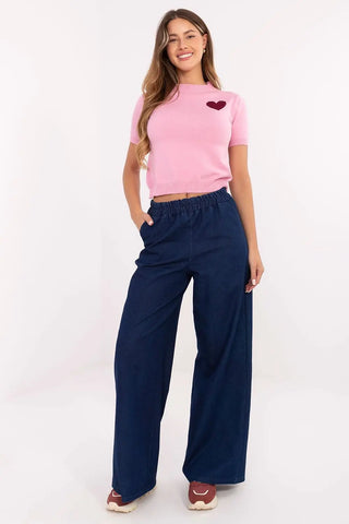 Woman wearing high-waist denim wide leg jeans with elastic waistband and side slip pockets
