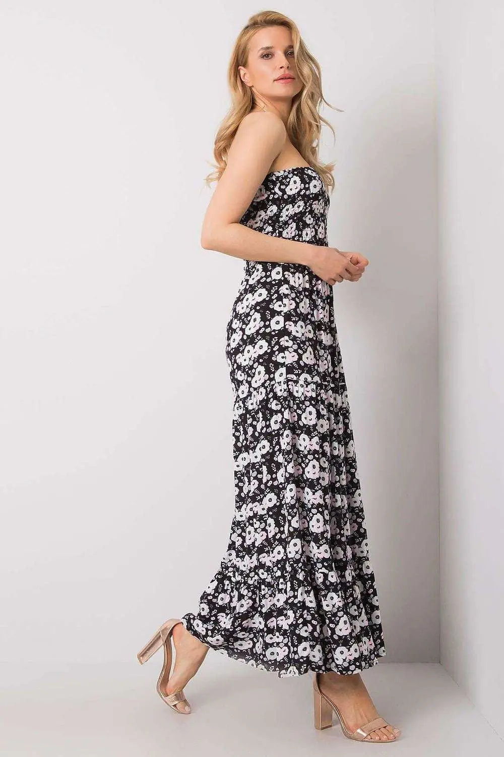 Long summer dress with floral pattern and ruffle hem, worn by a model.