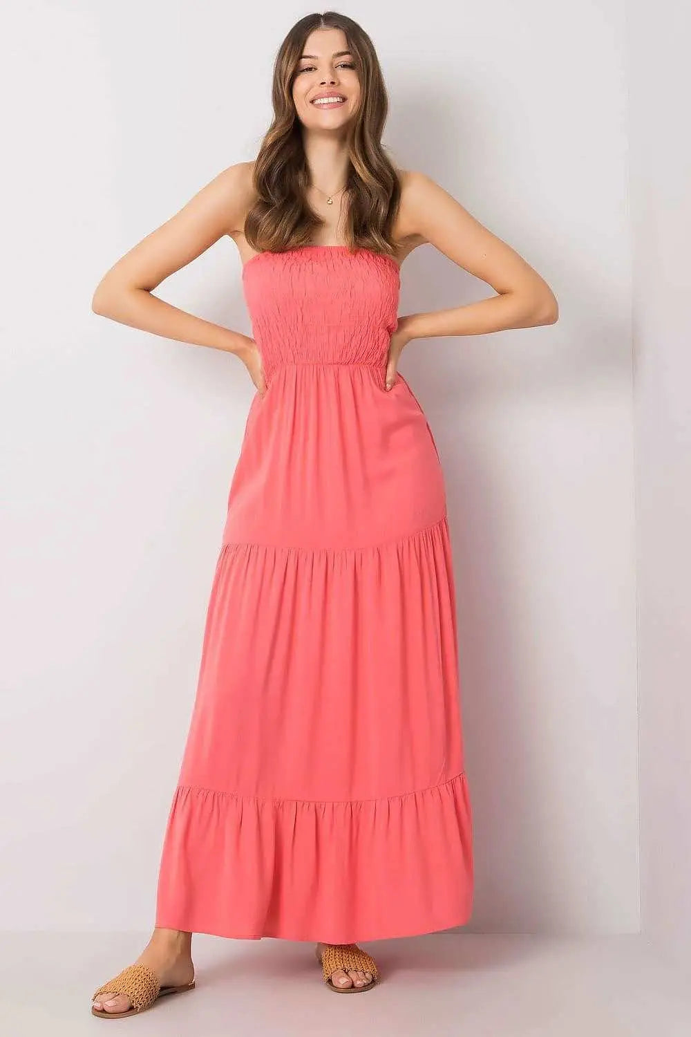 Long summer dress without straps, elastic top, and ruffled bottom for breezy comfort.