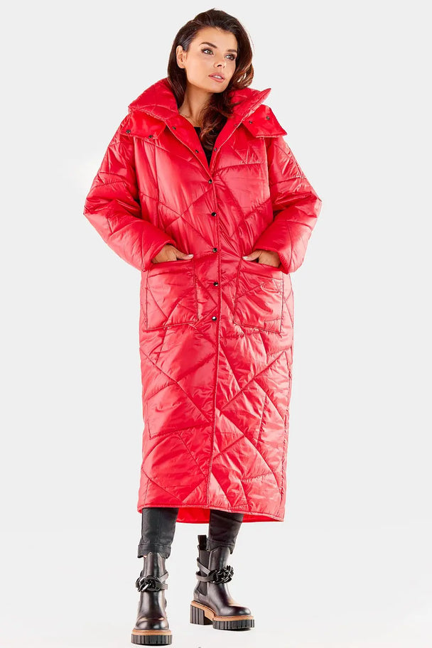 Woman wearing red long quilted coat with hood and pockets, perfect for autumn and winter