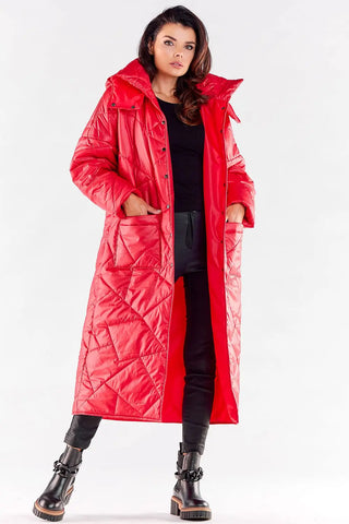 Woman wearing elegant long red quilted coat with hood and large pockets