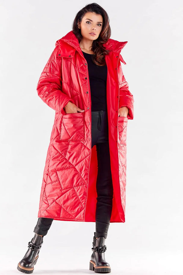 Woman wearing elegant long red quilted coat with hood and large pockets