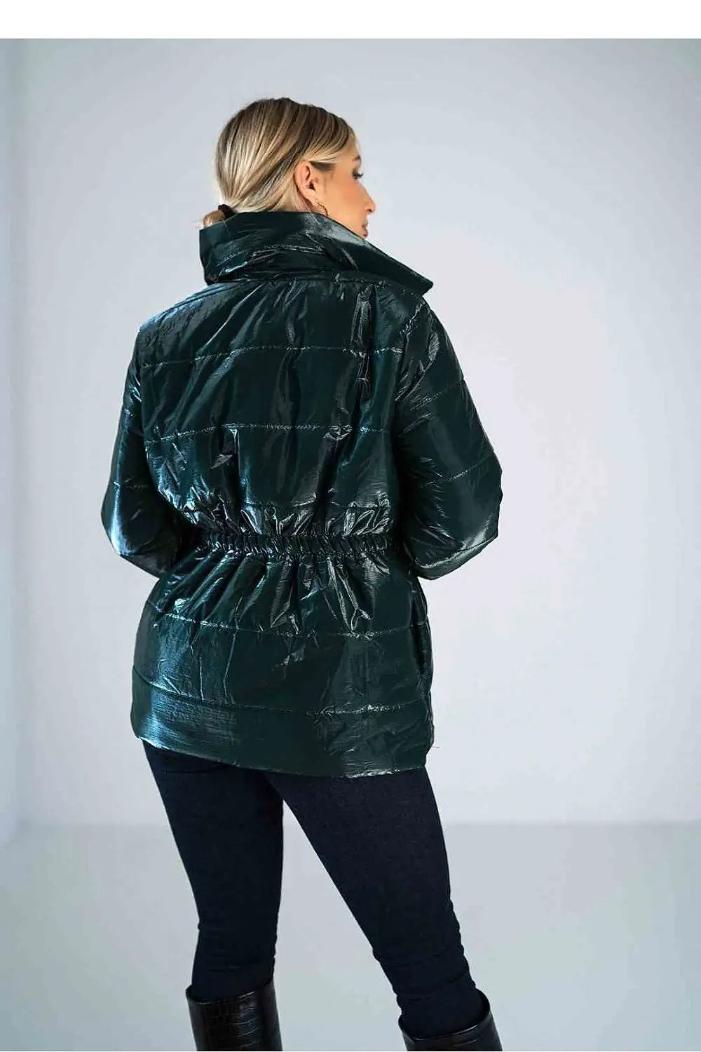Back view of women’s shiny quilted jacket with high collar and elastic waist.