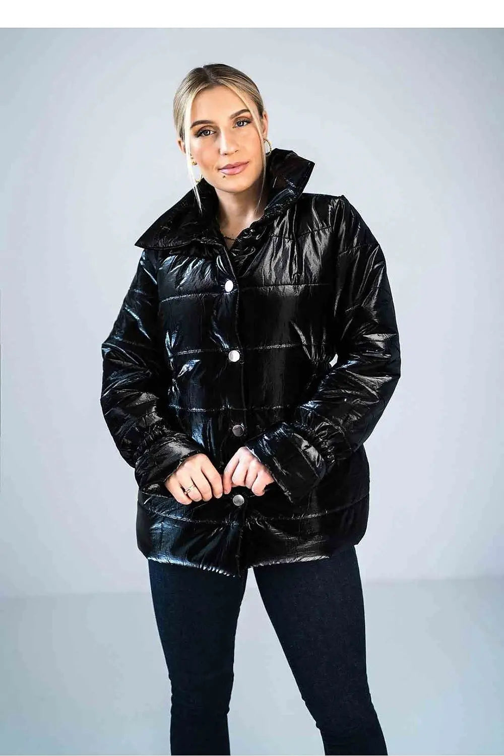 Women’s shiny black quilted jacket with high collar and press studs closure