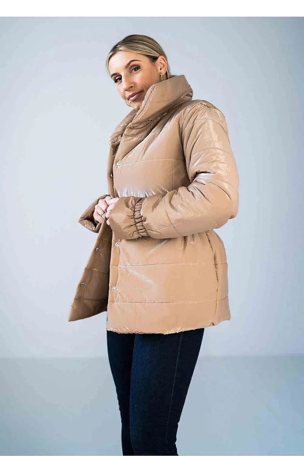 Women’s shiny quilted hip-length beige jacket with high collar and elastic sleeves