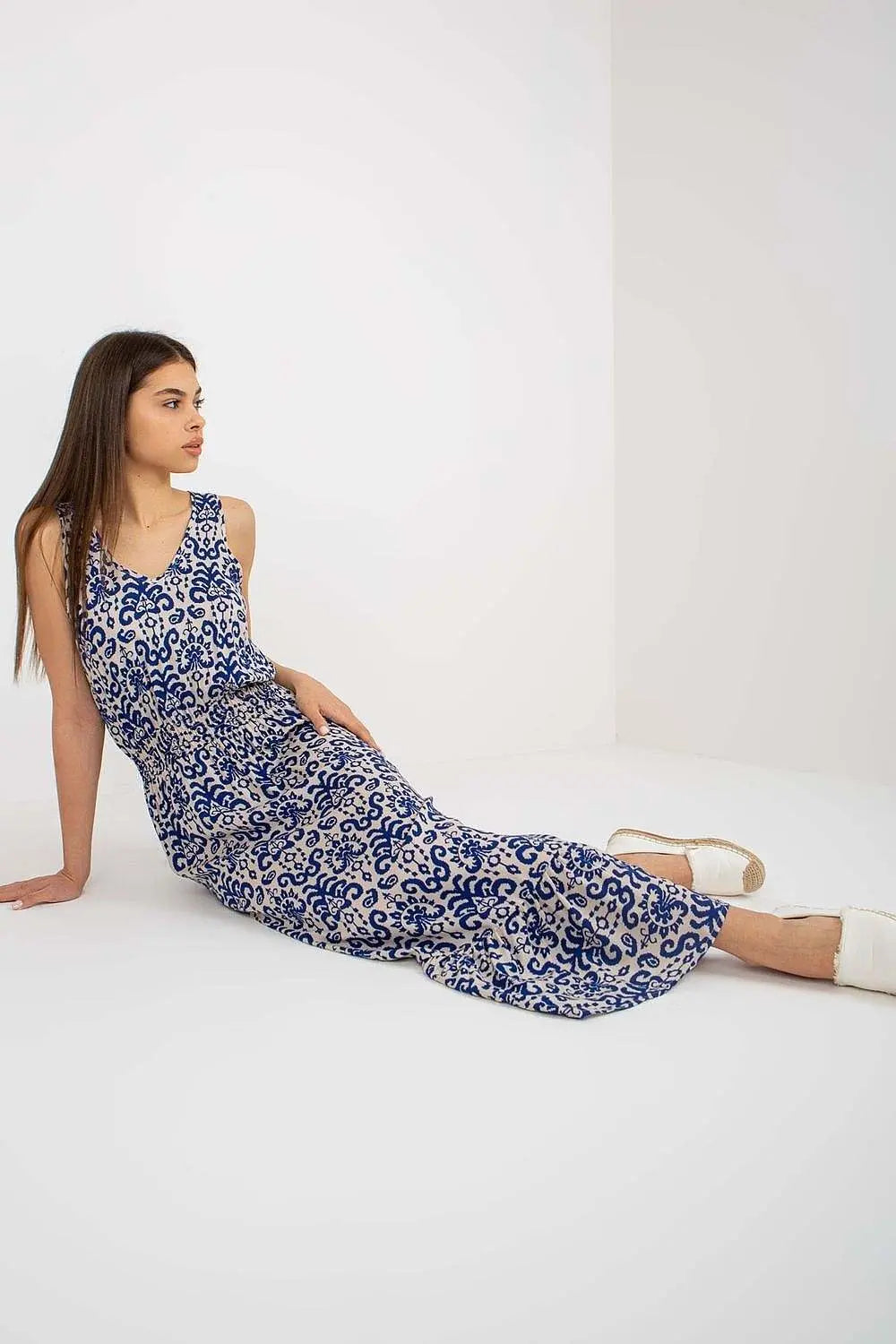 Summer floral dress with thick straps and heart neckline, featuring a cinched waist and ruffled hem.