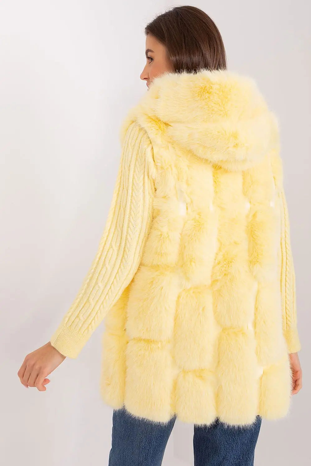 Women’s hooded faux fur vest in soft yellow with pockets and zipper closure, perfect for warmth and style.