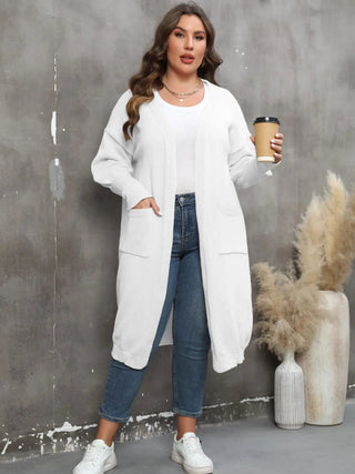 Plus size long sleeve white pocketed cardigan with open front and ribbed texture worn by woman