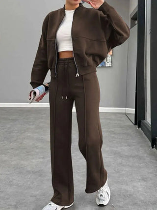 Woman wearing brown baseball collar zip up outerwear and drawstring pants set with white sneakers