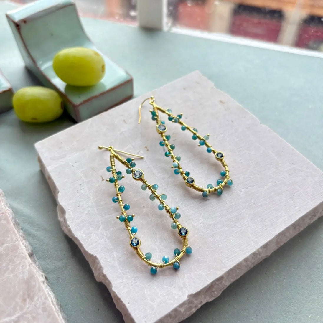 Hydra Large Teardrop wire-wrapped earrings with iolite, blue topaz, and apatite gemstones on 22k gold recycled brass