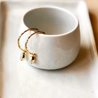 Hydra Gold and Pearl Hoops artisan handcrafted 22K gold textured hoops with natural pearl drops, 28mm diameter, displayed on ceramic bowl