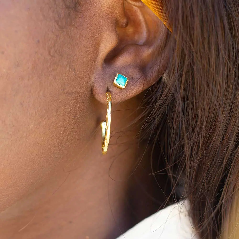 Close-up of an ear wearing Lydia Textured Gold Hoops 22mm handcrafted 22kt gold plated earrings
