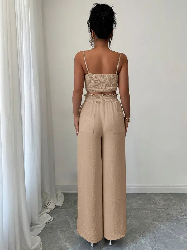 Back view of woman wearing light beige suspender vest and wide-leg pants two-piece suit