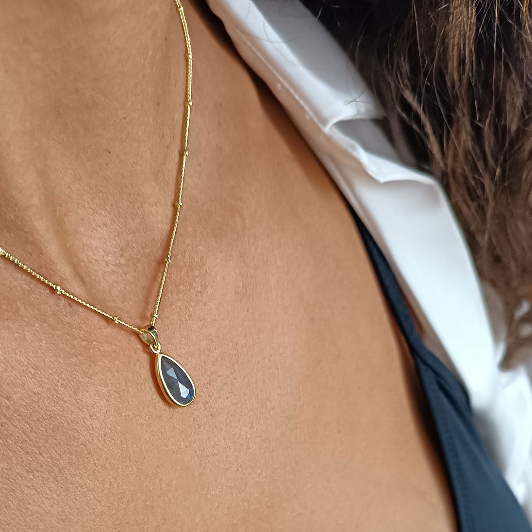 Simi Teardrop Gemstone Pendant featuring labradorite on adjustable 22k gold recycled brass chain worn on neck