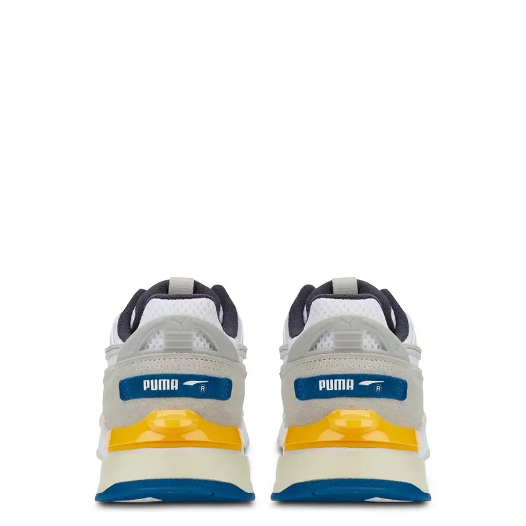 Rear view of Puma MIRAGE-SPORT Sneakers in white, grey, yellow, and blue with suede and mesh upper, rubber sole, and round toe design.